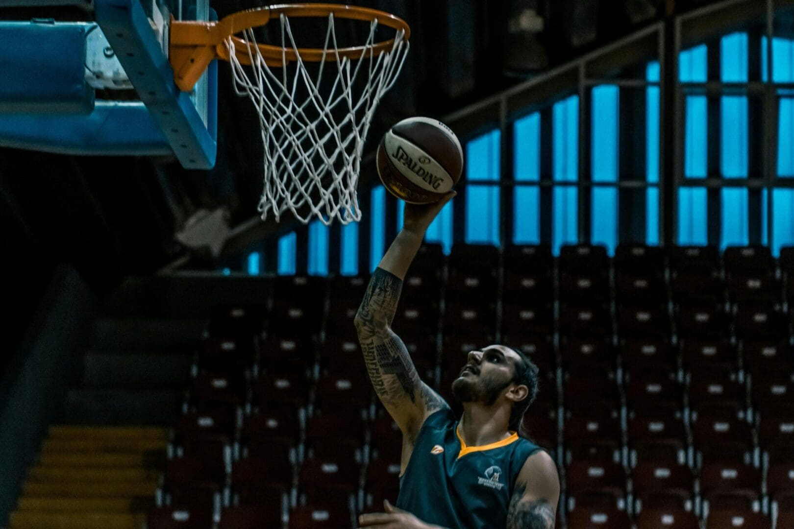 A man that is playing basketball in the air