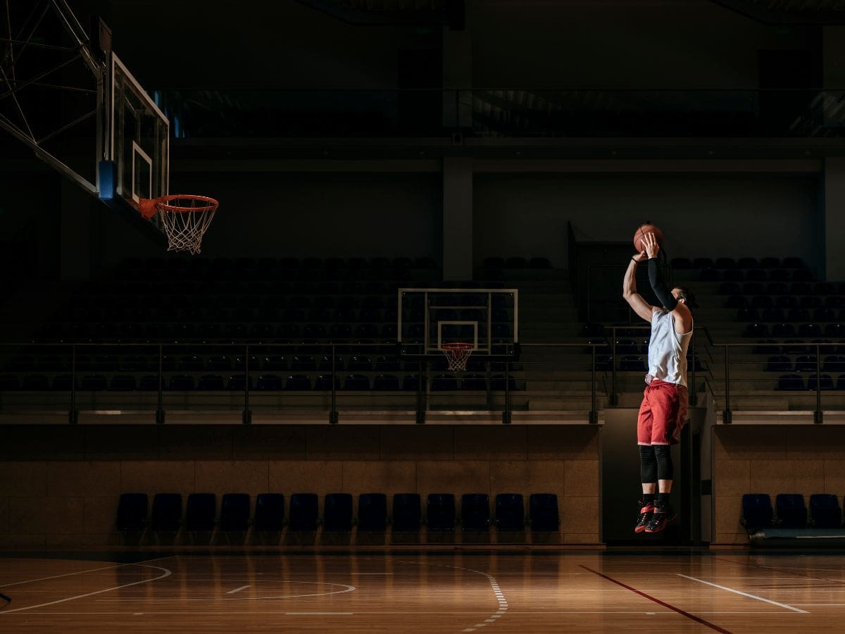 A man is playing basketball on the court